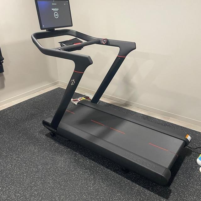 Peloton treadmill set up in a home gym