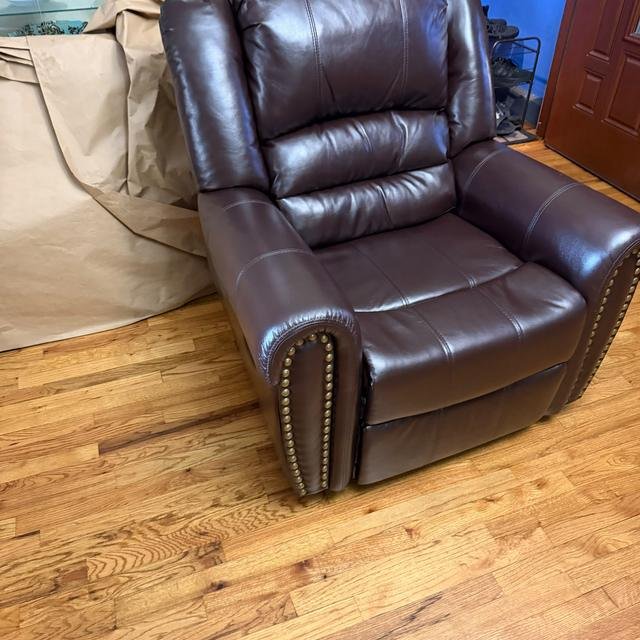 Brown leather recliner, set up in a living room